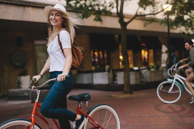 Beautiful female riding bicycle in the city