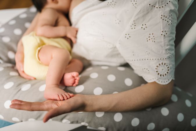 Mother feeding baby at home