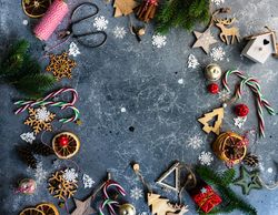 Christmas ornaments, string, candy canes and fir scattered on marble table