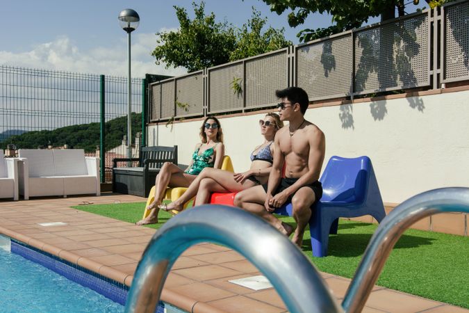 Group of friends sunbathing by the on a summer day
