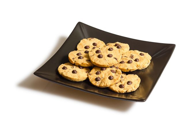 Chocolate chip cookies on a dark plate isolated on plain background