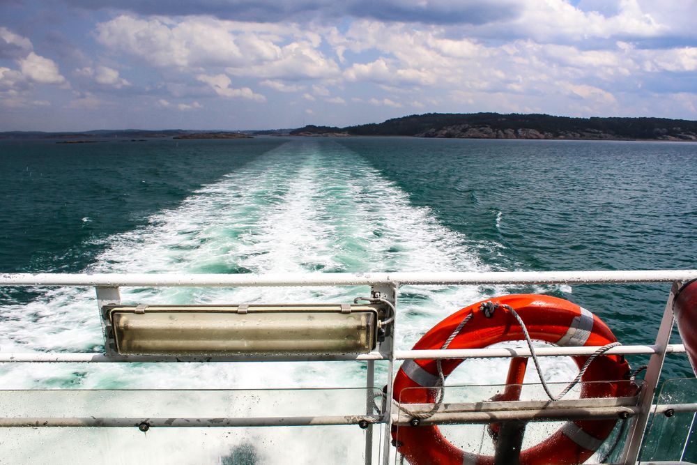Red life floater on boat in sea