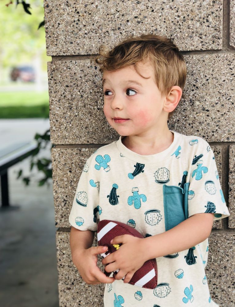 Young boy holding rugby ball in his hands