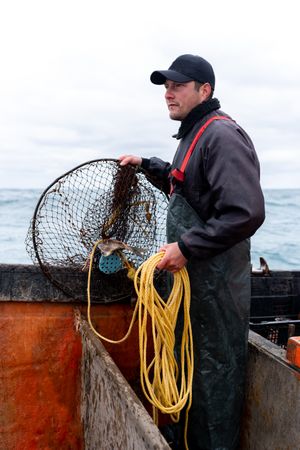 Fisherman working retreating a net from water