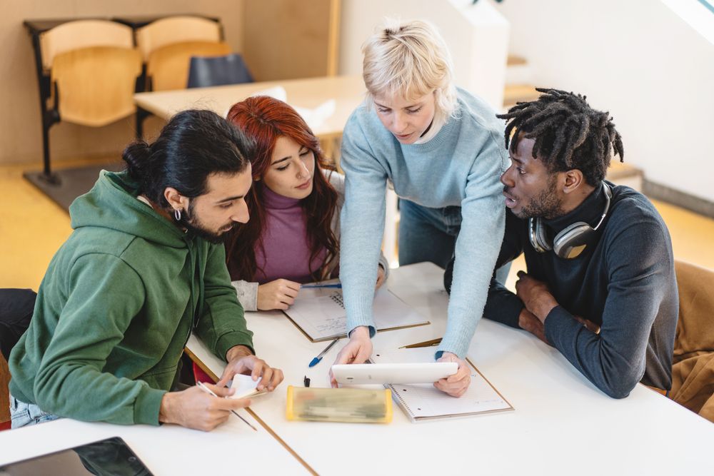 Diverse group of students engaging in a focused group discussion over coursework