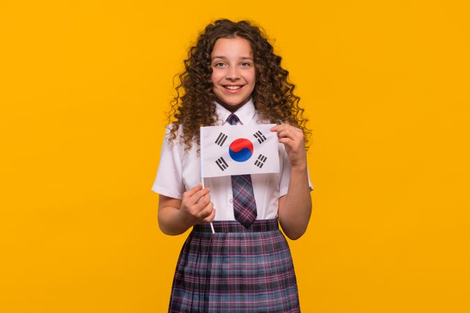 Smiling girl holding South Korean flag