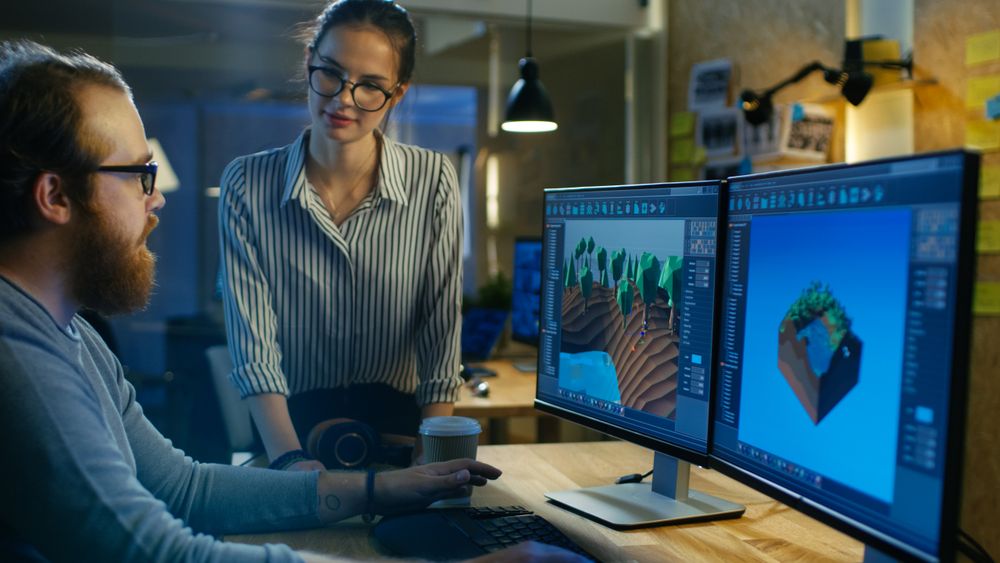 Male Game Developer Talks with Artistic Female Level Designer.