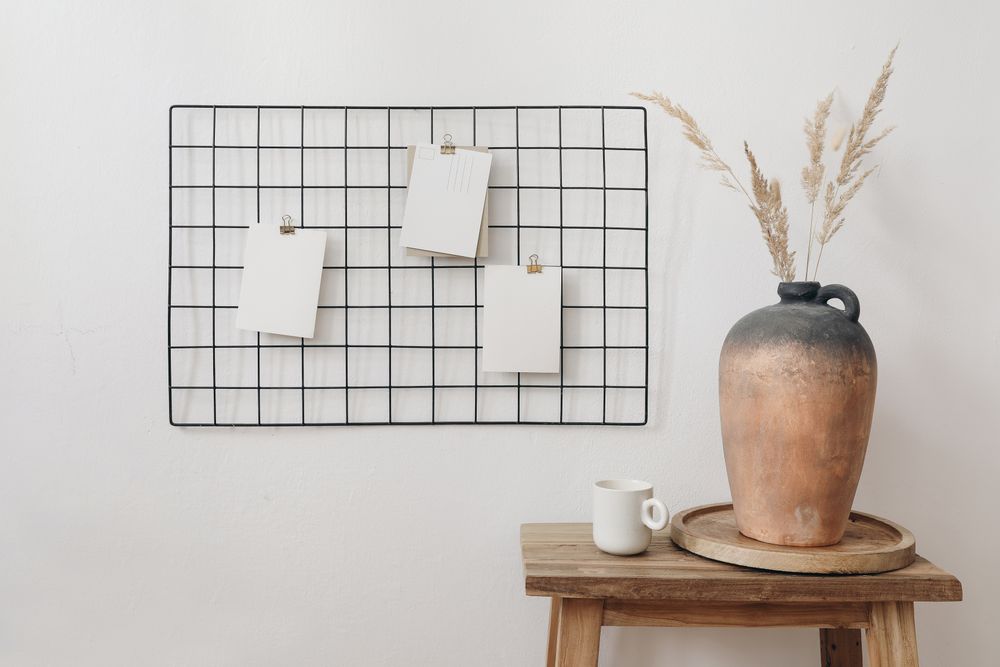 Paper notes pinned on grid in neutral room