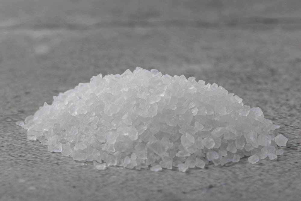 Handful of coarse salt on the table.
