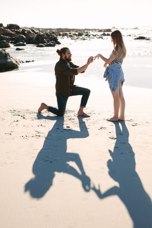 Man proposing marriage to his girlfriend on the beach