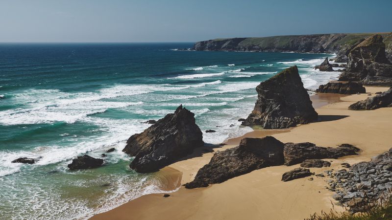 Waves coming into a rocky beach in Cornwall, wide