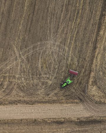 Aerial view of tractor working on farmland