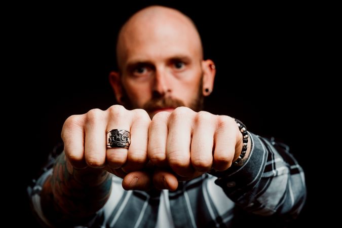 Young bald guy showing fists