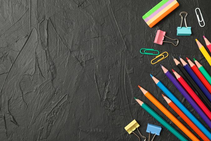 Composition with school supplies on dark background, space for text