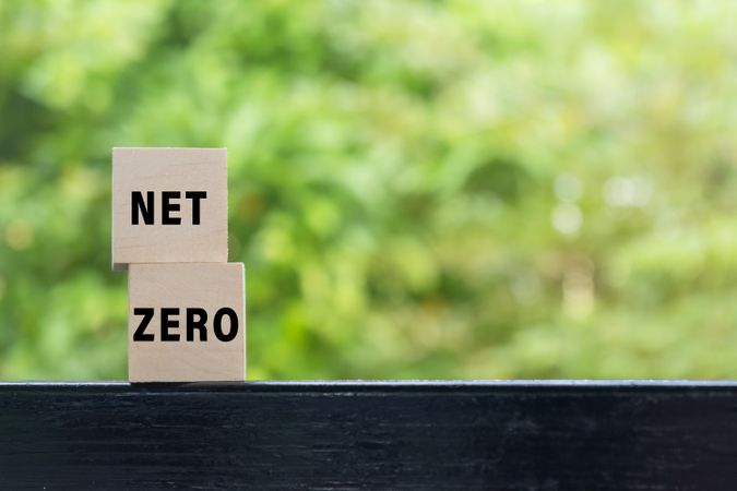 net zero words text on wooden blocks isolated on green nature background. carbon neutral net zero emissions concept