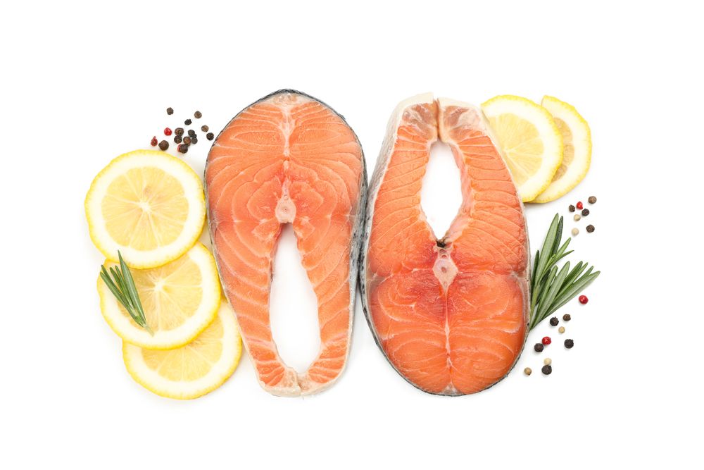 Fresh raw salmon meat and spices isolated on light background