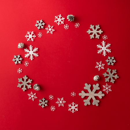 Circle made of snowflakes on red background