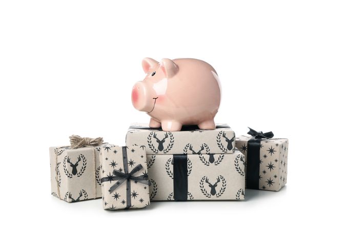 Concept of Christmas finance with piggy bank, isolated on light background