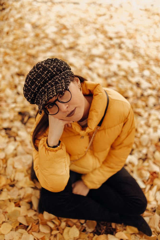Woman sitting on autumn leaves
