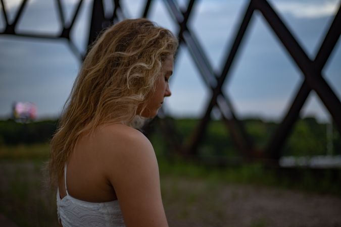 Side view of sad young woman standing outdoor