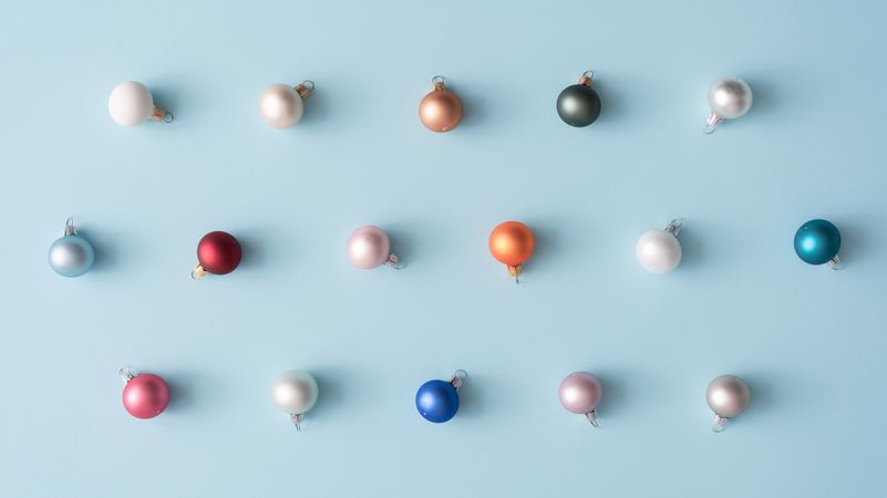 Colorful Christmas baubles on blue pastel background