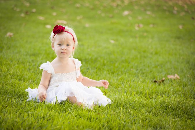 Girl Wearing White Dress In A Grass Field