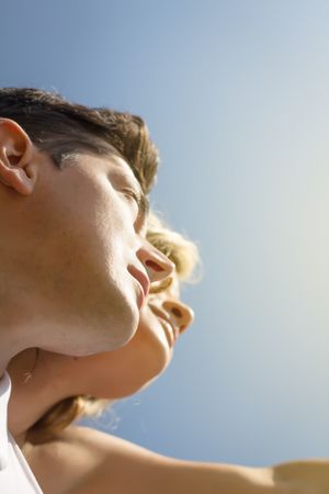 Bottom view of love couple looking a blue sky