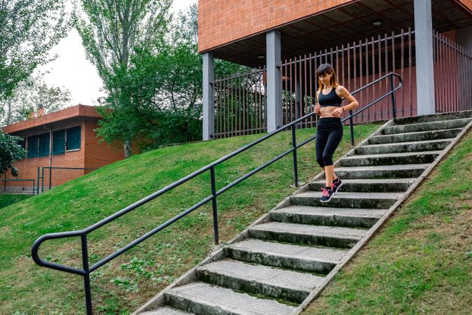 Female athlete going down stairs outdoors
