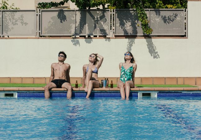 Group of friends sunbathing by the on a summer day
