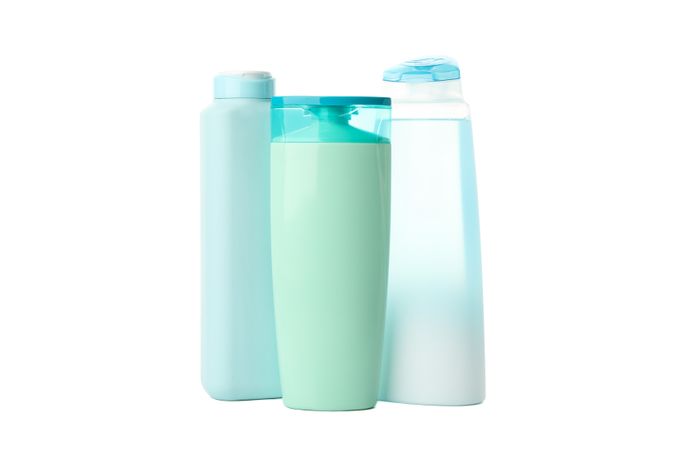 Blank plastic shampoo or lotion bottles isolated on light background