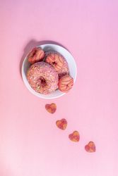 Pink doughnuts with heart shape candies