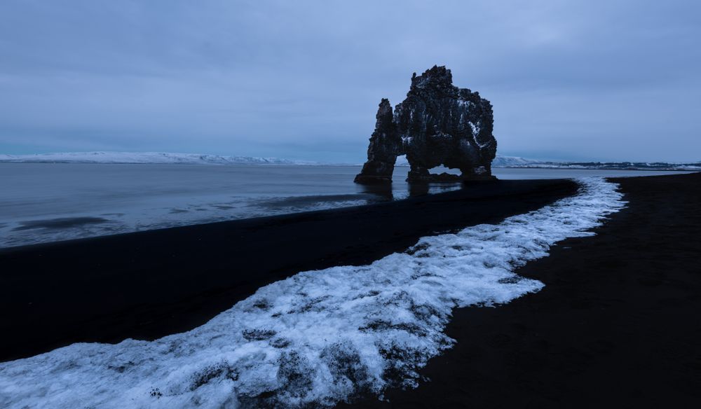 Rocky shoreline of sea in clouds in Iceland