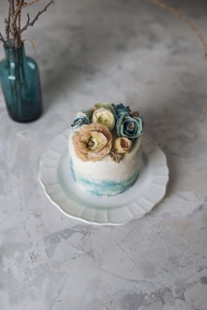 Buttercream flowers cake, blue and pastel peach colors