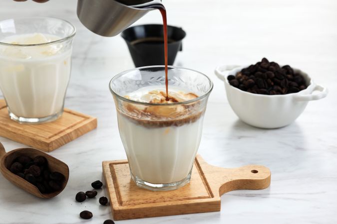 Pouring Coffee Shot to the Glass with Cold Fresh Milk