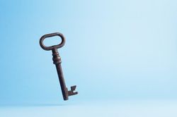 Vintage key falling over blue background