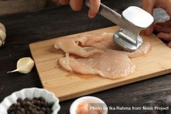Hands of cook tenderizing chicken breast 5kq3jb