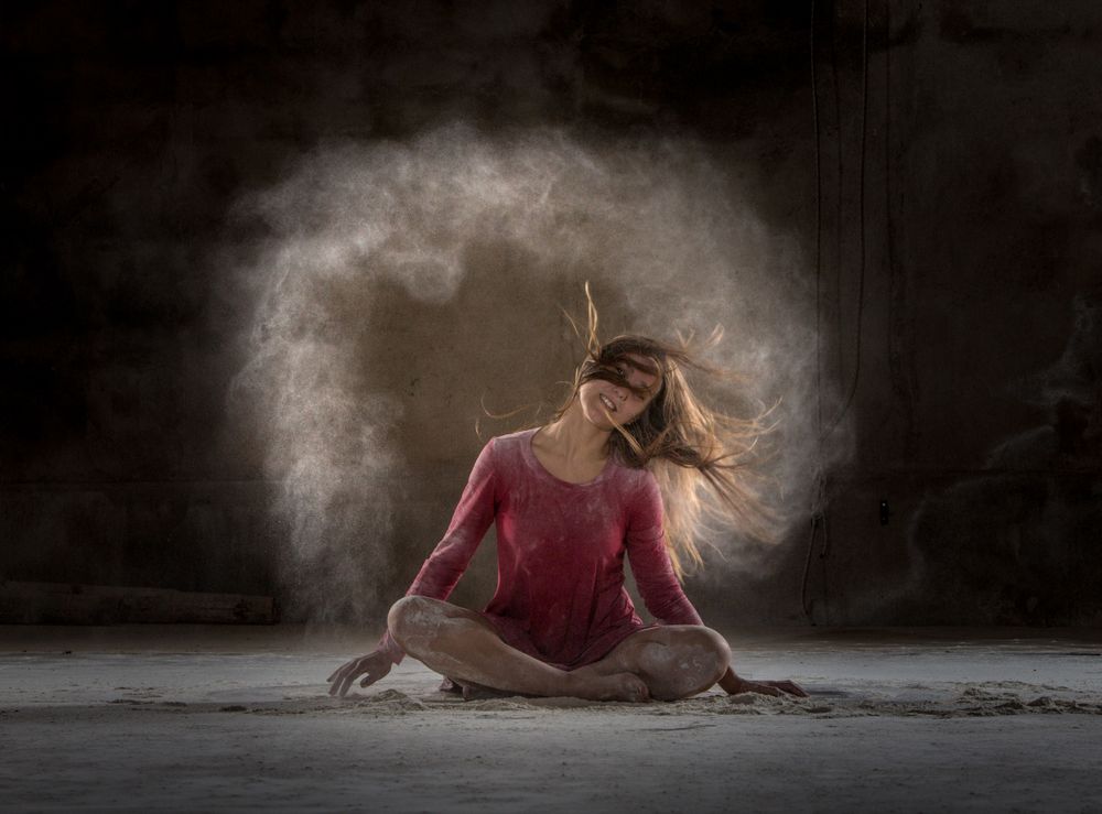 Young woman between fog in darkness