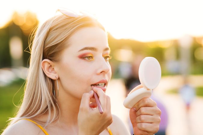 Woman does makeup on street