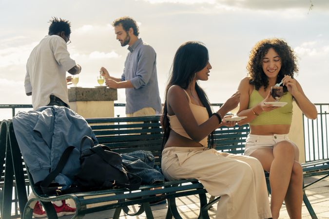 Group of friends eating granita outdoors on vacation