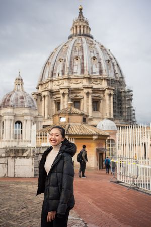 Overjoyed Asian female traveler walking at old city