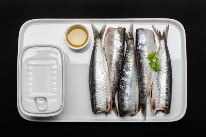 Raw fish without heads on plate