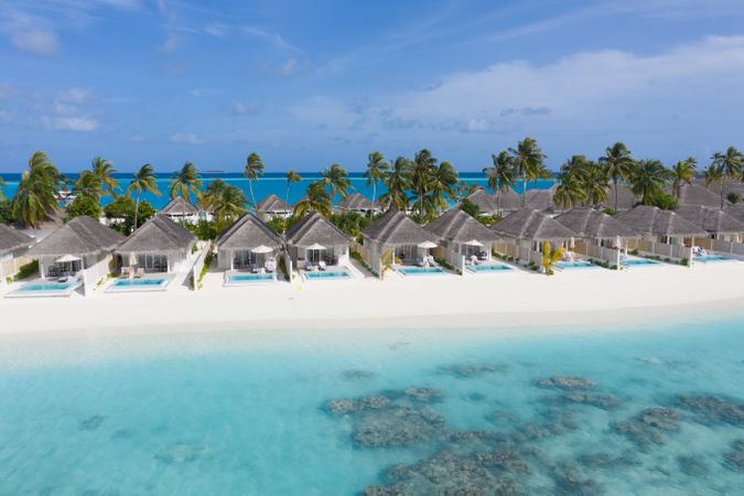 Holiday villas line the beach in the tropical Maldives