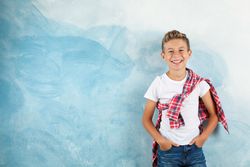 Happy boy against color background, space for text