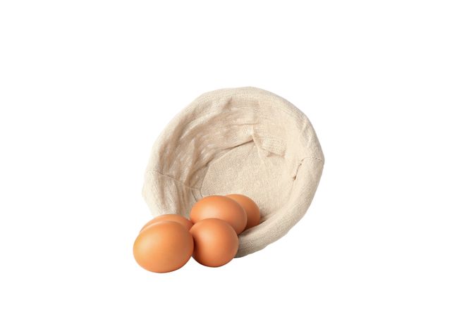 eggs in a round basket, isolated on blank background.