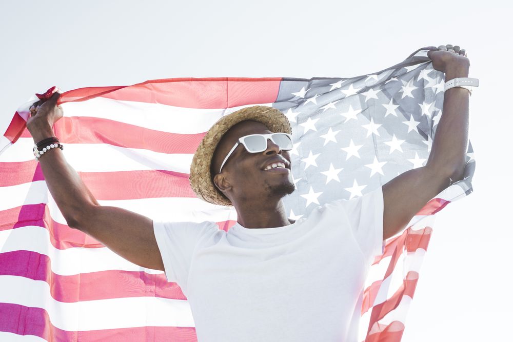 Cheerful black man with American flag