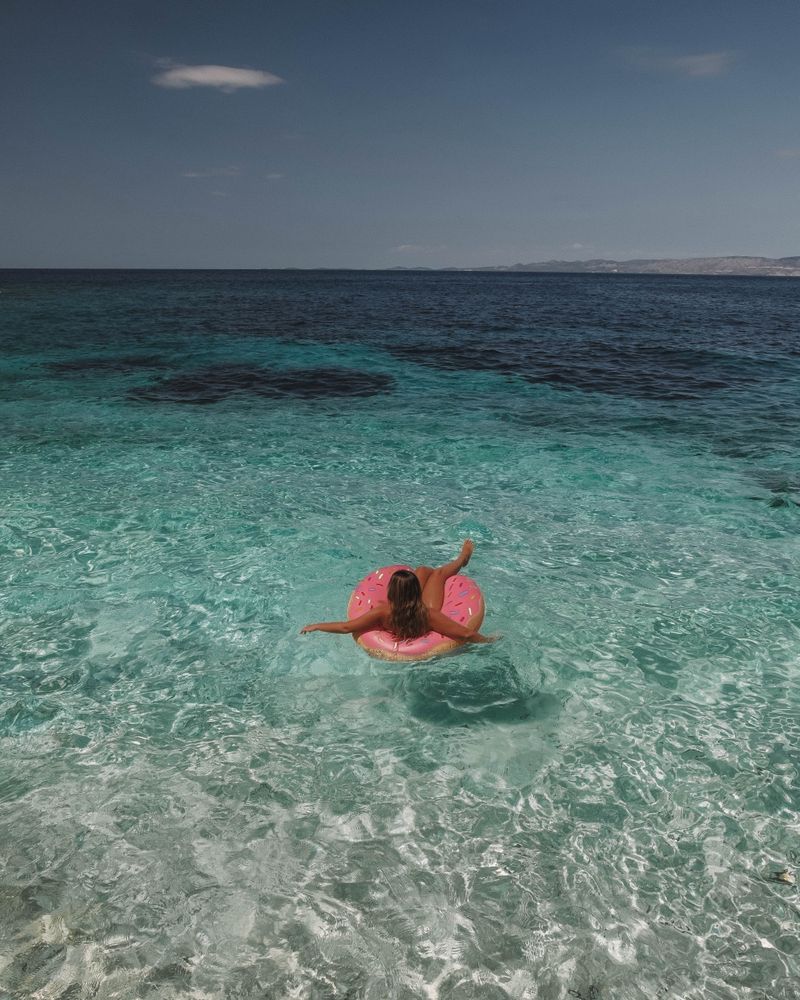 Woman sitting on inflatable ring floating in the sea