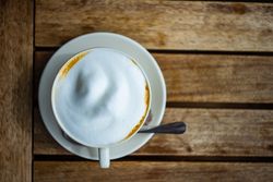 Top view of cup of frothy morning cappuccino
