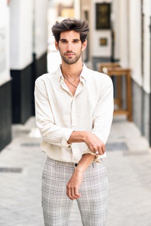 Handsome man standing in street with plaid trousers