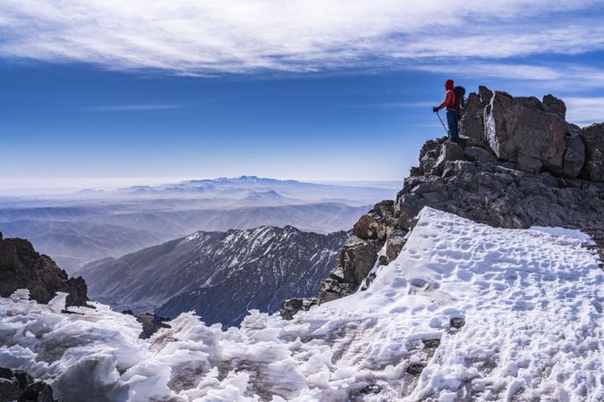 Tourist enjoying breathtaking view at snowy mountain top