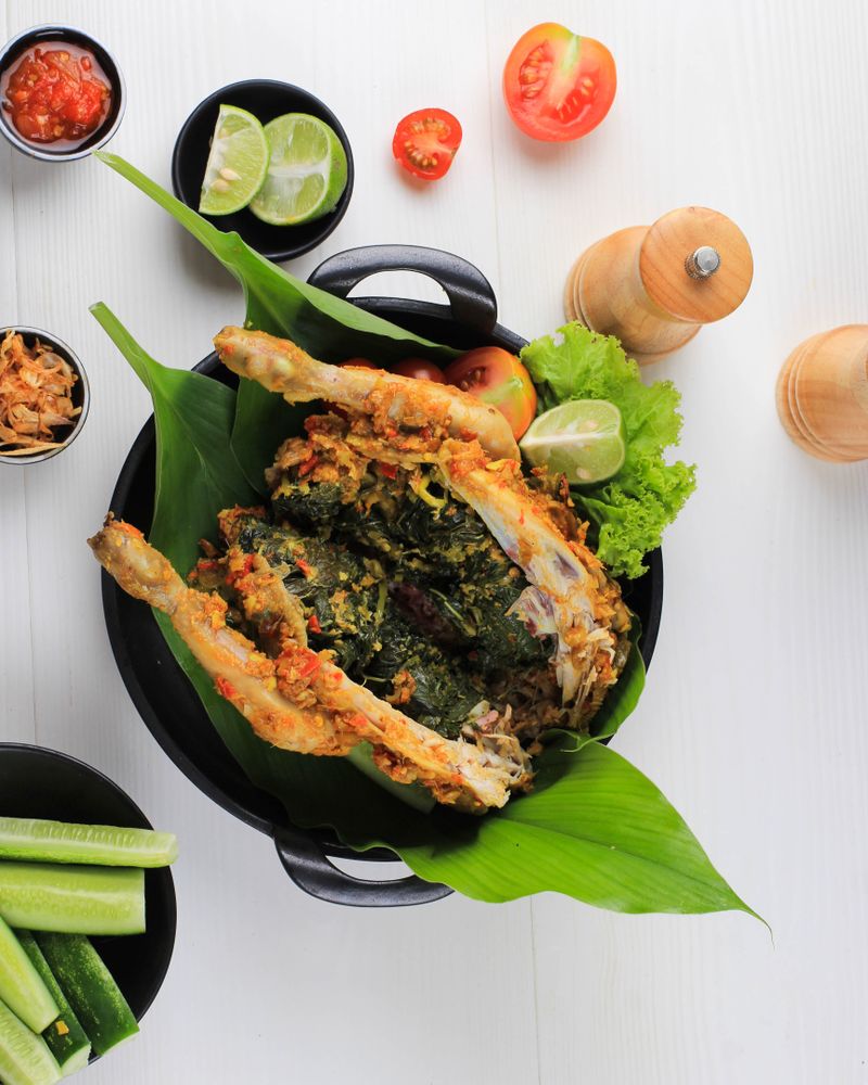 Ayam Betutu, Balinese Roast Chicken Stuffed with Cassava Leaves.